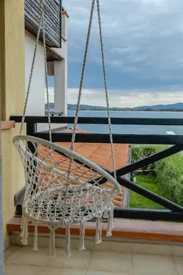 a swinging chair on a balcony with a view at Lovely 3BD flat with PARKING and SEA VIEW by Flаt Manаger in Chernomorets