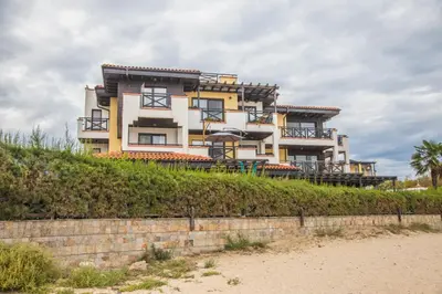 a building on top of a hill next to the beach at Lovely 3BD flat with PARKING and SEA VIEW by Flаt Manаger in Chernomorets