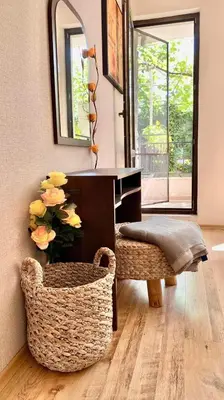 a desk with a bench and a vase with flowers at Sozopol Dreams apartman 35 in Sozopol