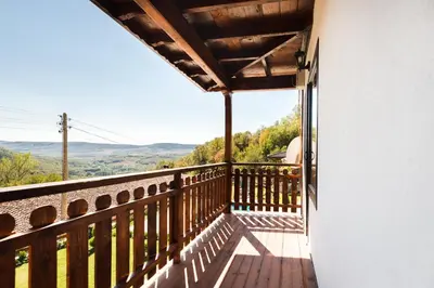 a balcony with a view of the mountains at Guest House Hristova Kashta - Христова Къща in Cherni Vrŭkh