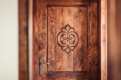 a wooden door with a design on it at Guest House Hristova Kashta - Христова Къща in Cherni Vrŭkh