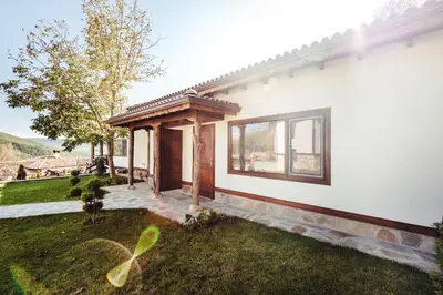 a white house with a gazebo at Guest House Hristova Kashta - Христова Къща in Cherni Vrŭkh