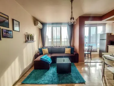 a living room with a couch and a table at LunApart in Varna City