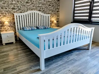 a white crib in a room with a brick wall at Aпартамент 5 in Varna City