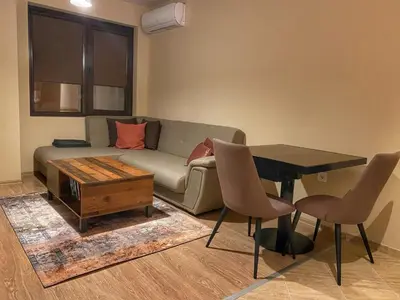 a living room with a couch and a table at Stylish URBAN Apart New 2021 Close to the Beach in Varna City