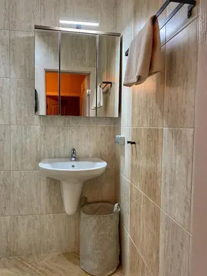 a bathroom with a sink and a mirror at Stylish URBAN Apart New 2021 Close to the Beach in Varna City