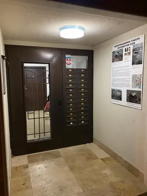 a hallway with a black door and a poster on the wall at Stylish URBAN Apart New 2021 Close to the Beach in Varna City
