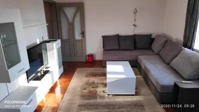 a living room with a couch and a tv at UNIQUE LOCATION APARTMENT WITH PARKING in Burgas City
