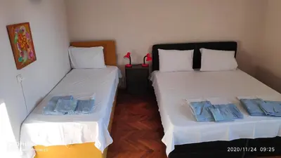 two beds sitting next to each other in a room at UNIQUE LOCATION APARTMENT WITH PARKING in Burgas City