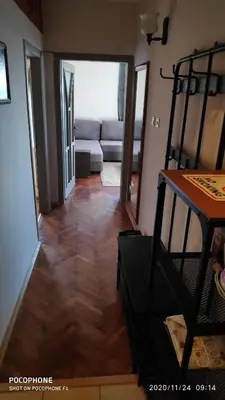 a living room with a couch and a wooden floor at UNIQUE LOCATION APARTMENT WITH PARKING in Burgas City