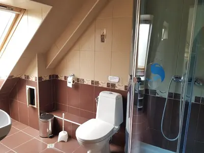 a small bathroom with a toilet and a shower at CarolMike Oasis Beach Apartment Kamchia Reserve in Kamchia