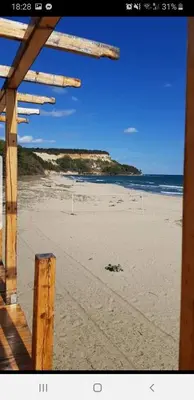 a view of a sandy beach with the ocean at CarolMike Oasis Beach Apartment Kamchia Reserve in Kamchia
