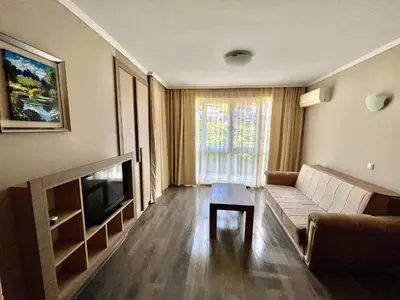 a living room with a couch and a television at Villa Orange in Sozopol