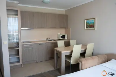 a small kitchen with a table and a microwave at Villa Orange in Sozopol