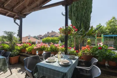 a table on a patio with flowers and plants at VILLA SOL in Sunny Beach