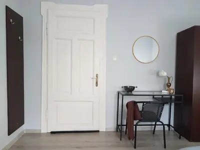 a door in a room with a table and a mirror at Flat in Varna, central location, close to beach in Varna City