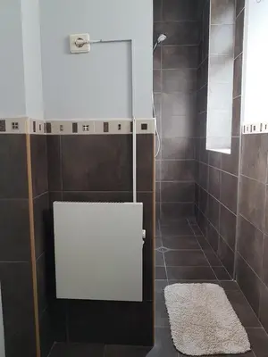 a bathroom with a shower with brown tiles at Flat in Varna, central location, close to beach in Varna City