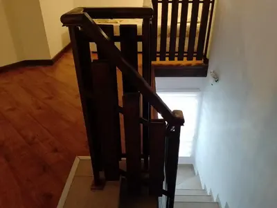 a stairway with a wooden railing and a stair case at Pearl Apartments Sozopol in Sozopol