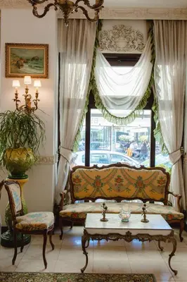 a living room with a couch and a window at Royal Hotel in Varna City