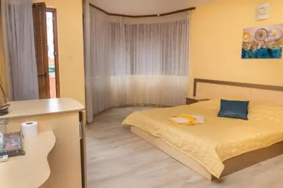 a bedroom with a bed in a room at Къща за гости КАТИ in Kiten