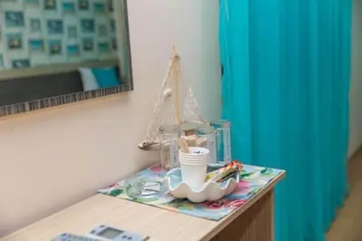 a table with a mirror and a toy boat on it at Къща за гости КАТИ in Kiten