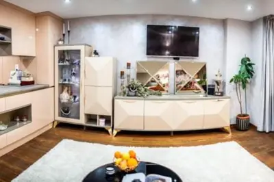 a living room with a table and a tv at A&K COZY ART Studio 1 in Varna City