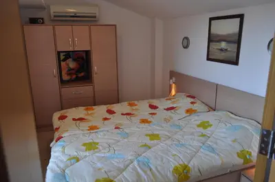 a bedroom with a bed with a colorful comforter at Beautiful family villa with sea view in Byala