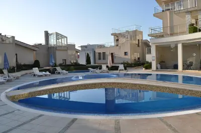 a swimming pool in the courtyard of a building at Beautiful family villa with sea view in Byala