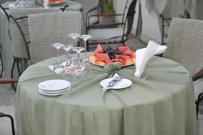 a table with a bowl of fruit on it at Boryana Hotel in Burgas City