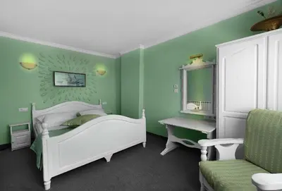 a green bedroom with a white bed and a desk at Boryana Hotel in Burgas City