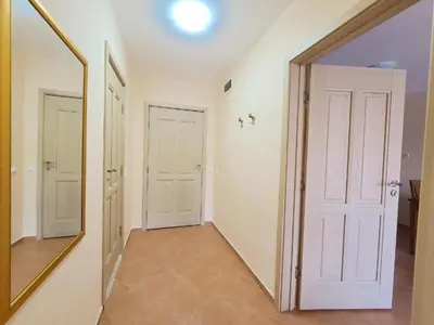 a hallway with a mirror and white doors at Kalia Apartment Sunny Beach 2-Zimmer+Balkon TOP in Sunny Beach