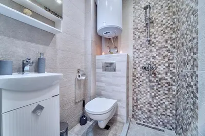 a bathroom with a toilet sink and a shower at Апартамент S Apart in Varna City