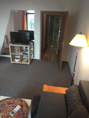 a living room with a couch and a tv at студио Маргрете in Burgas City