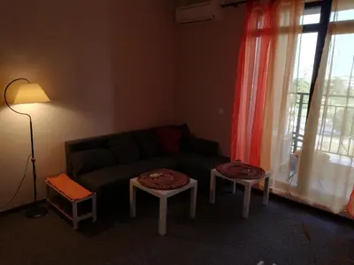 a living room with a couch and two tables at студио Маргрете in Burgas City