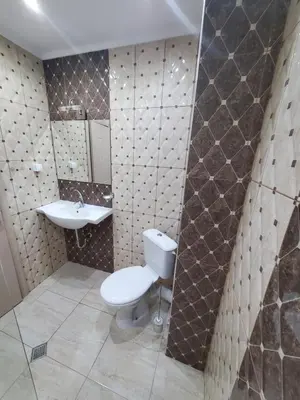 a bathroom with a toilet and a sink at Апартамент Анели in Pomorie