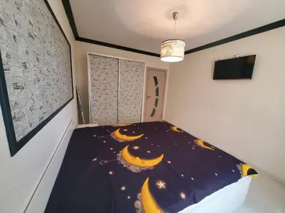 a bedroom with a bed with a crescent at Апартамент Анели in Pomorie