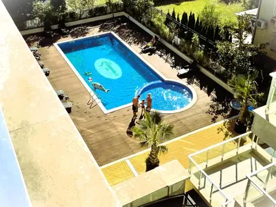 an overhead view of a swimming pool with people in it at Apartments Stamopolu Lux with pool view in Primorsko