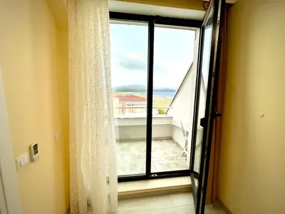 a window in a room with a view of a balcony at Sea View Apartment free parking in Primorsko