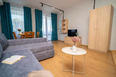 a living room with a couch and a table at Via Pontica 123 Guest Apartments in Sozopol