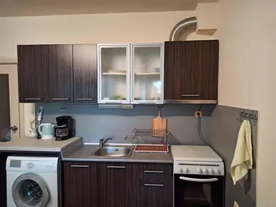 a kitchen with a sink and a washing machine at Apartment Relax Lozenets in Lozenets