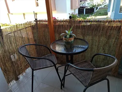 a table with two chairs and a potted plant on a patio at Apartment Relax Lozenets in Lozenets