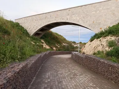 a stone bridge over a brick path under a hill at Apartment Relax Lozenets in Lozenets