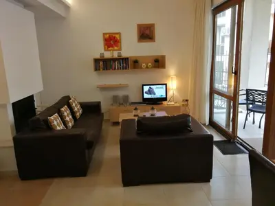 a living room with two couches and a tv at Cozy family villa 500m. from the beach in Byala