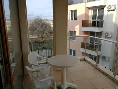 a balcony with a table and chairs on a balcony at Cozy family villa 500m. from the beach in Byala