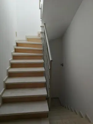 a staircase in a house with wooden steps at Cozy family villa 500m. from the beach in Byala