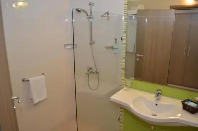 a bathroom with a shower and a sink at Aqua Nevis Hotel & Aqua Park - All Inclusive in Sunny Beach