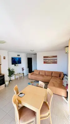 a living room with a couch and a table at Villa CALABRIA in Sveti Vlas