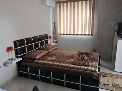 a large bed in a room with a window at Studio Emi in Pomorie
