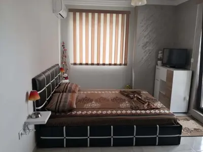 a large bed in a room with a window at Studio Emi in Pomorie