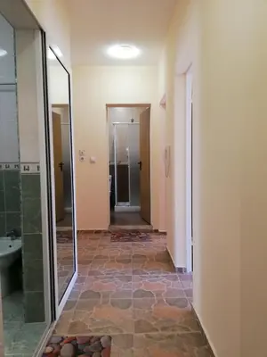 a bathroom with a walk in shower and a glass door at Самостоятелни стаи Виктория in Pomorie